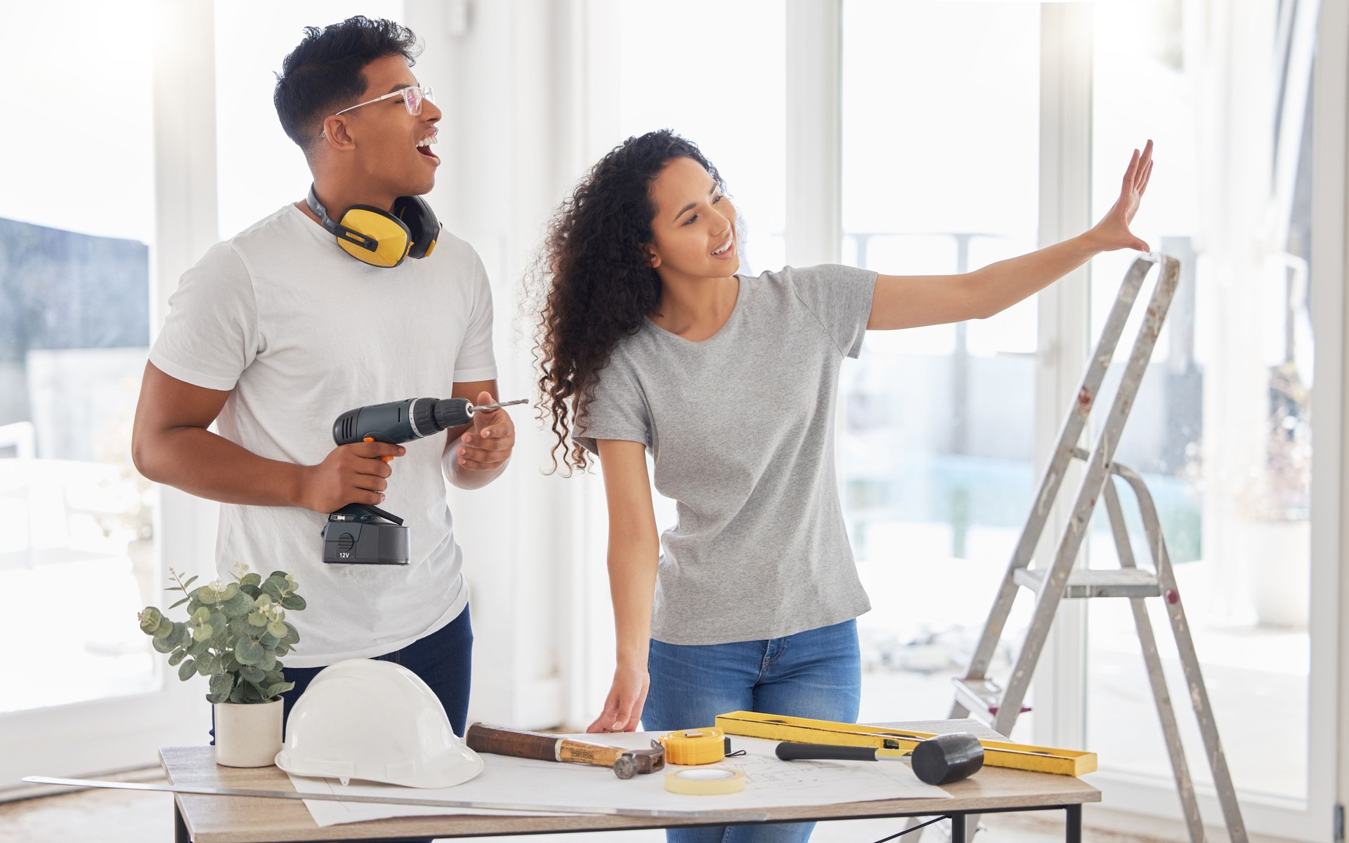 Shot of a young couple renovating a house together